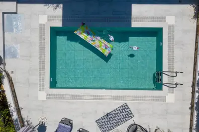 an overhead view of a swimming pool with a umbrella at Mikaela's Pool House in Afantou