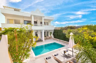 a villa with a swimming pool and a house at Mikaela's Pool House in Afantou