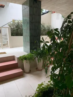 a patio with potted plants and a column and stairs at Central Grinn-in the heart of Rhodes,new&stylish! in Rhodes Town