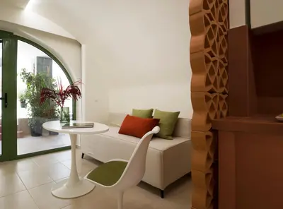 a living room with a white couch and a table at Central Grinn-in the heart of Rhodes,new&stylish! in Rhodes Town