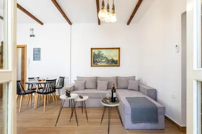 a living room with a couch and a table at Medieval Poem in Rhodes Town
