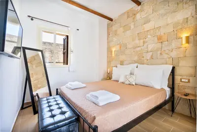 a bedroom with a bed with two towels on it at Medieval Poem in Rhodes Town