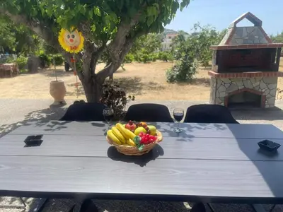a table with a basket of fruit and wine glasses at Aegean Endless Summer Villa Pefkos in Pefki Rhodes