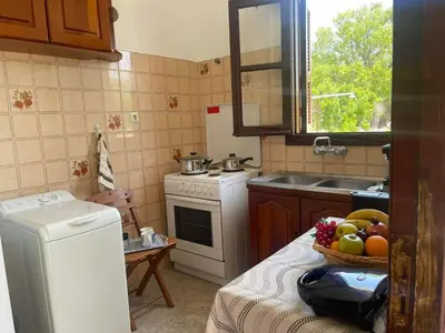 a kitchen with a white refrigerator and a bowl of fruit at Aegean Endless Summer Villa Pefkos in Pefki Rhodes