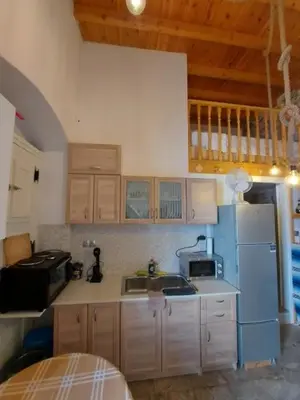 a kitchen with a blue refrigerator and a sink at Ήλιος Πατσακης in Symi