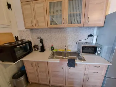 a kitchen with a sink and a microwave at Ήλιος Πατσακης in Symi
