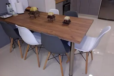 a dining room table with white chairs around it at Andreas Apartment in Rhodes Town