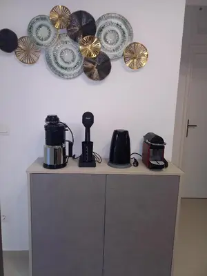 a counter with plates and appliances on a wall at Andreas Apartment in Rhodes Town