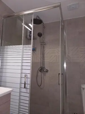 a shower with a glass door in a bathroom at Andreas Apartment in Rhodes Town