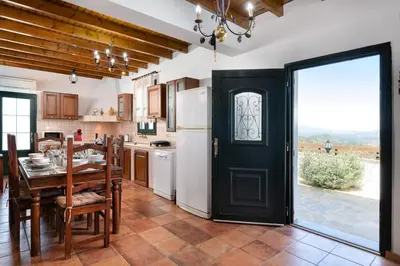 a kitchen with a table and a black door at Pure Nature Cottage in Láerma