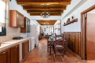 a kitchen with a table and a dining room at Pure Nature Cottage in Láerma