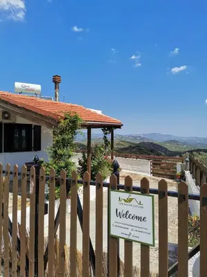 a wooden fence with a welcome sign in front of a house at Pure Nature Cottage in Láerma