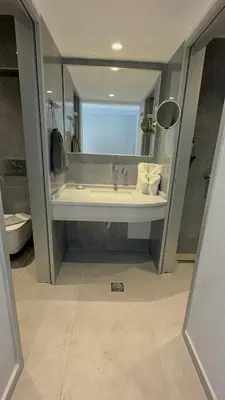 a bathroom with a sink and a large mirror at Amaryllis front beach hotel in Lardos
