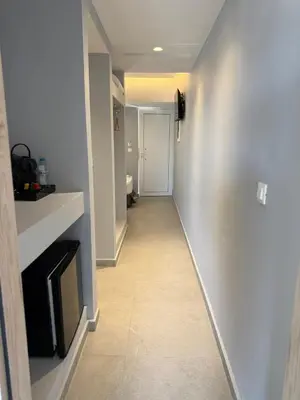 a hallway leading to a room with a fireplace at Amaryllis front beach hotel in Lardos