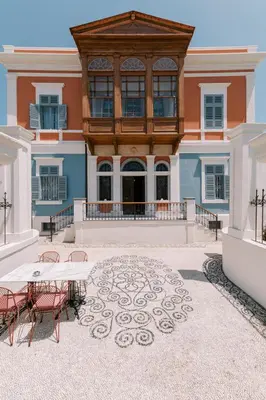 a patio with a table and chairs in front of a building at Saray Monumental Luxury Villa Medieval Town, Rhodes in Rhodes Town