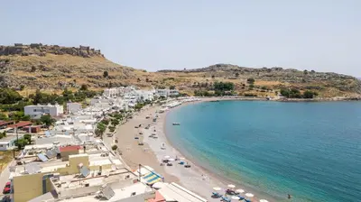 a view of a beach with people and the ocean at Haraki Blue Dream Luxury Apartments in Haraki