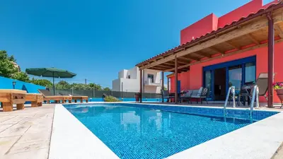 a swimming pool in front of a house at Olympia Villa in Gennadi