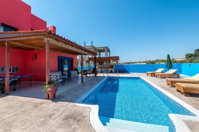 a villa with a swimming pool and a patio at Olympia Villa in Gennadi