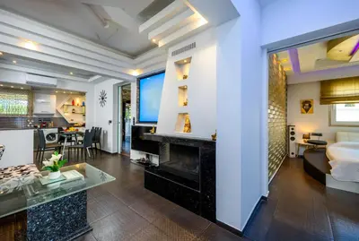 a living room with a fireplace and a couch at Pervolia House Private Villa Near Airport in Kremasti