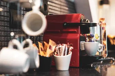 a coffee maker and cups on a counter at Pervolia House Private Villa Near Airport in Kremasti