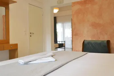 a bedroom with a bed with white towels on it at mascot traditional guest house in Rhodes Town