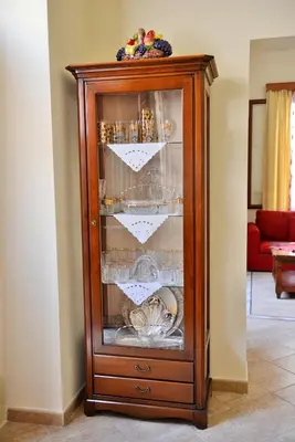 a wooden cabinet with a cat sleeping in it at Classical Villa Archontiko D&M in Rhodes Town