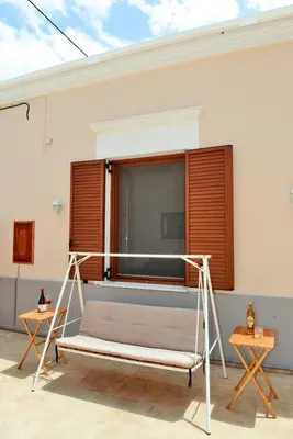 a bed in a room with a window at Classical Villa Archontiko D&M in Rhodes Town