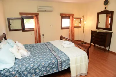 a bedroom with a bed with towels on it at Classical Villa Archontiko D&M in Rhodes Town