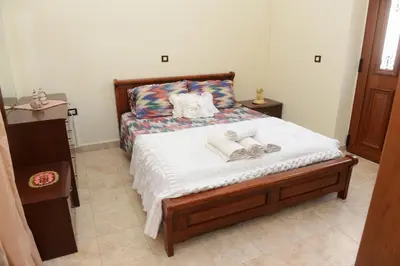 a bedroom with a bed with towels on it at Classical Villa Archontiko D&M in Rhodes Town