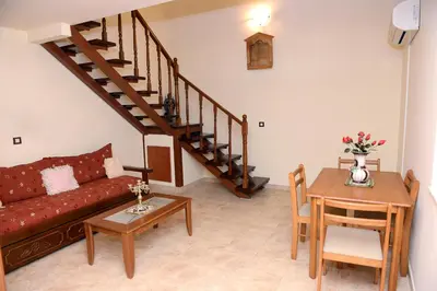 a living room with a couch and a table at Classical Villa Archontiko D&M in Rhodes Town