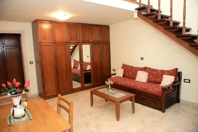 a living room with a couch and a table at Classical Villa Archontiko D&M in Rhodes Town