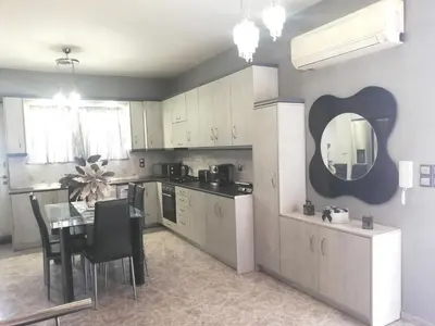 a kitchen with a table and a dining room at EnjoyRhodes Villa near Faliraki in Kalithies