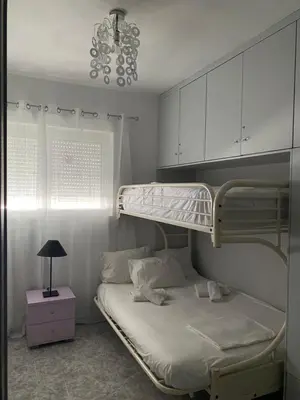 a bedroom with two bunk beds and a lamp at EnjoyRhodes Villa near Faliraki in Kalithies