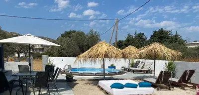 a patio with a table and chairs and a pool at EnjoyRhodes Villa near Faliraki in Kalithies