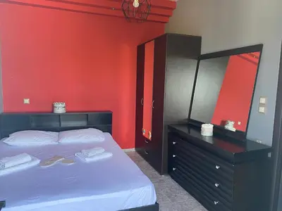 a bedroom with a bed and a dresser with a mirror at EnjoyRhodes Villa near Faliraki in Kalithies