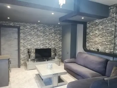 a living room with a couch and a tv at EnjoyRhodes Villa near Faliraki in Kalithies
