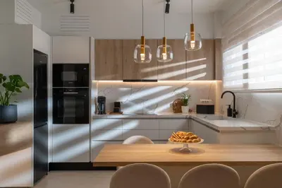 a kitchen with a wooden table and a counter top at Mariann Premium Suites in Lardos