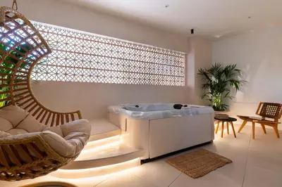 a living room with a tub and a chair at Mariann Premium Suites in Lardos