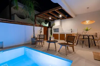 a living room with a swimming pool and a table and chairs at Mariann Premium Suites in Lardos