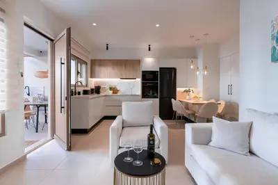 a living room with a white couch and a table at Mariann Premium Suites in Lardos