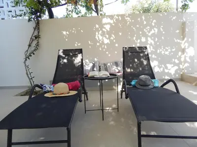 two chairs and a table with hats on them at Pervoli in Faliraki