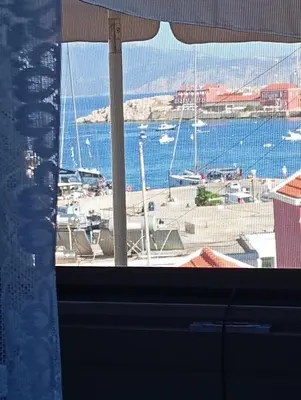a view from a window of a marina with boats at Casa Con Vista Apartments in Halki