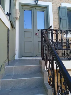 a front door of a house with stairs at Casa Con Vista Apartments in Halki