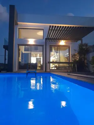 a swimming pool in front of a house at night at Casa di Rea Sanfilippo in Soroni