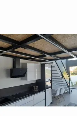 a kitchen with white cabinets and a staircase with chairs at Casa di Rea Sanfilippo in Soroni