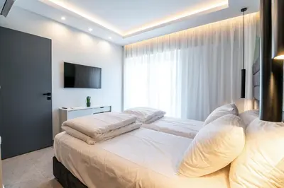 a bedroom with a large bed with white pillows at Unique Central Lee Pham Apartment in Rhodes Town