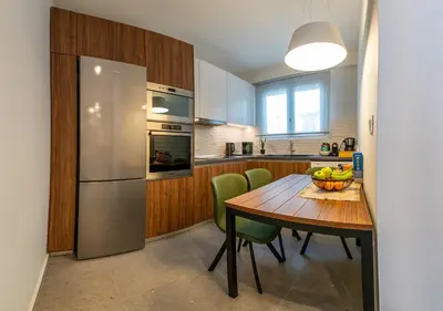 a kitchen with a wooden table with a bowl of fruit on it at Unique Central Lee Pham Apartment in Rhodes Town