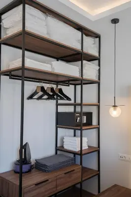 a black loft bed with wooden shelves in a room at Unique Central Lee Pham Apartment in Rhodes Town
