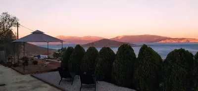 a group of trees with a view of the water at Marina Castellana Studios II in Halki