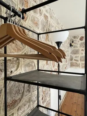 a staircase in a room with a stone wall at Marina Castellana Studios II in Halki